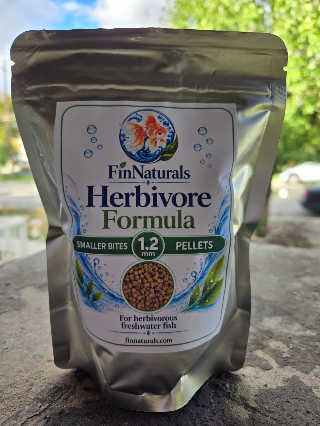 Actual FinNaturals Herbivore Smaller Bites Formula 1.2 mm silver pouch photographed outdoors, front label.