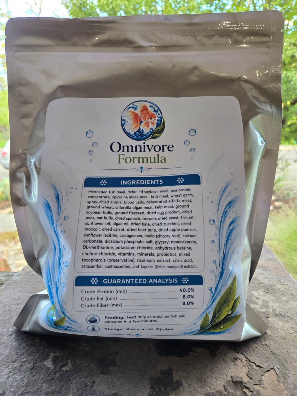 Actual Omnivore Formula 2.5 mm pouch photographed outdoors, back label with ingredients and guaranteed analysis.